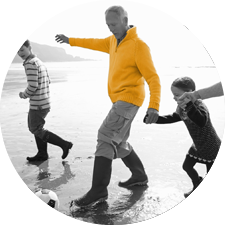 man playing with child on the beach