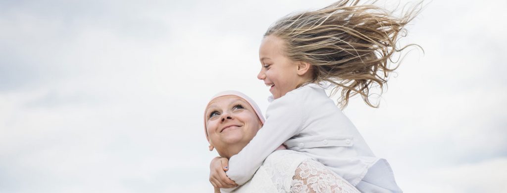 woman playing with child after cancer rehabilitation program