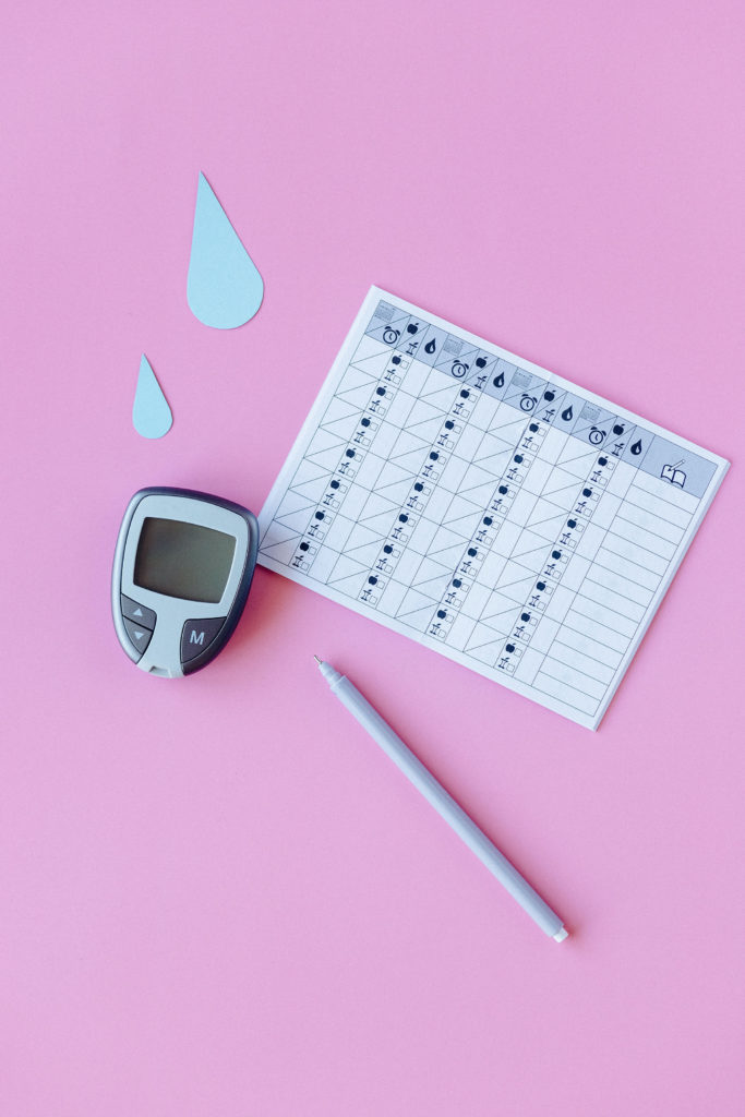 An insulin pump and blood sugar tracking chart for diabetes.
