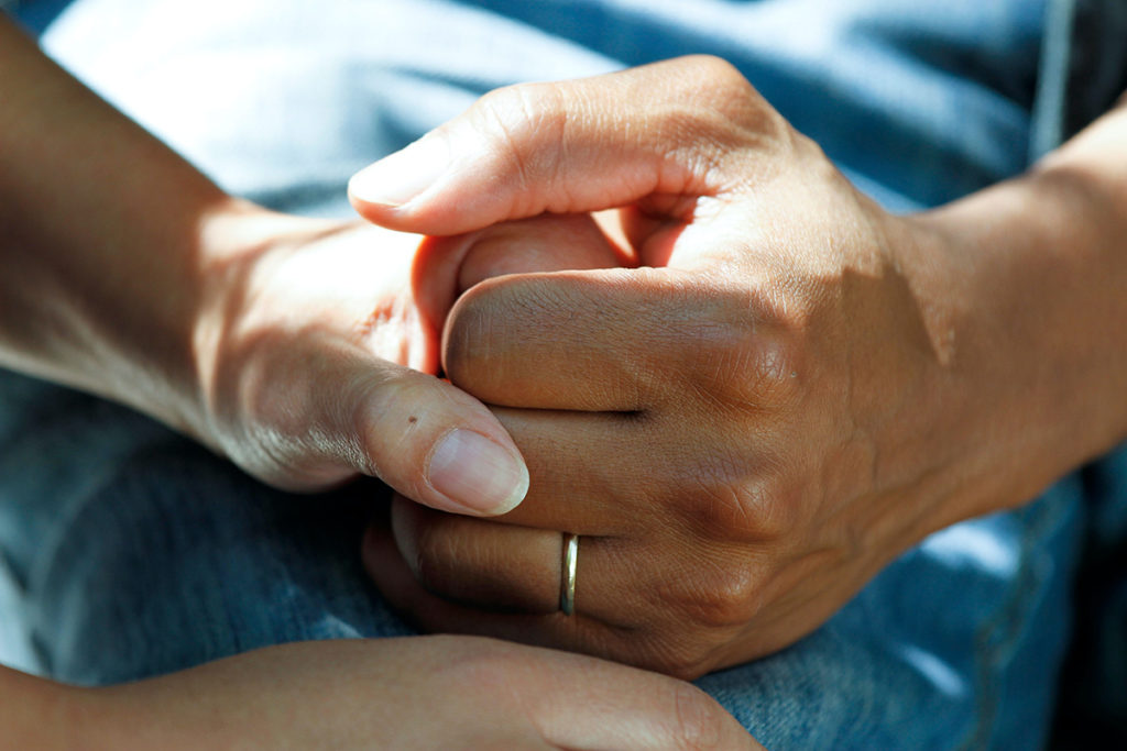 A close up of holding hands.